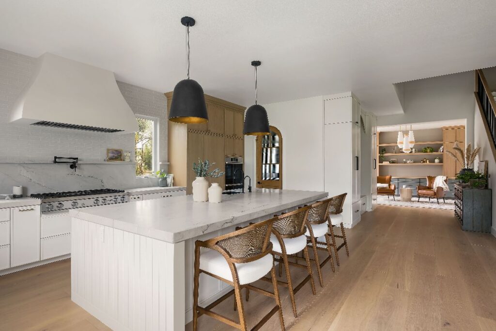 large kitchen with open load bearing wall removed with wide-plank wood flooring in kitchen with island