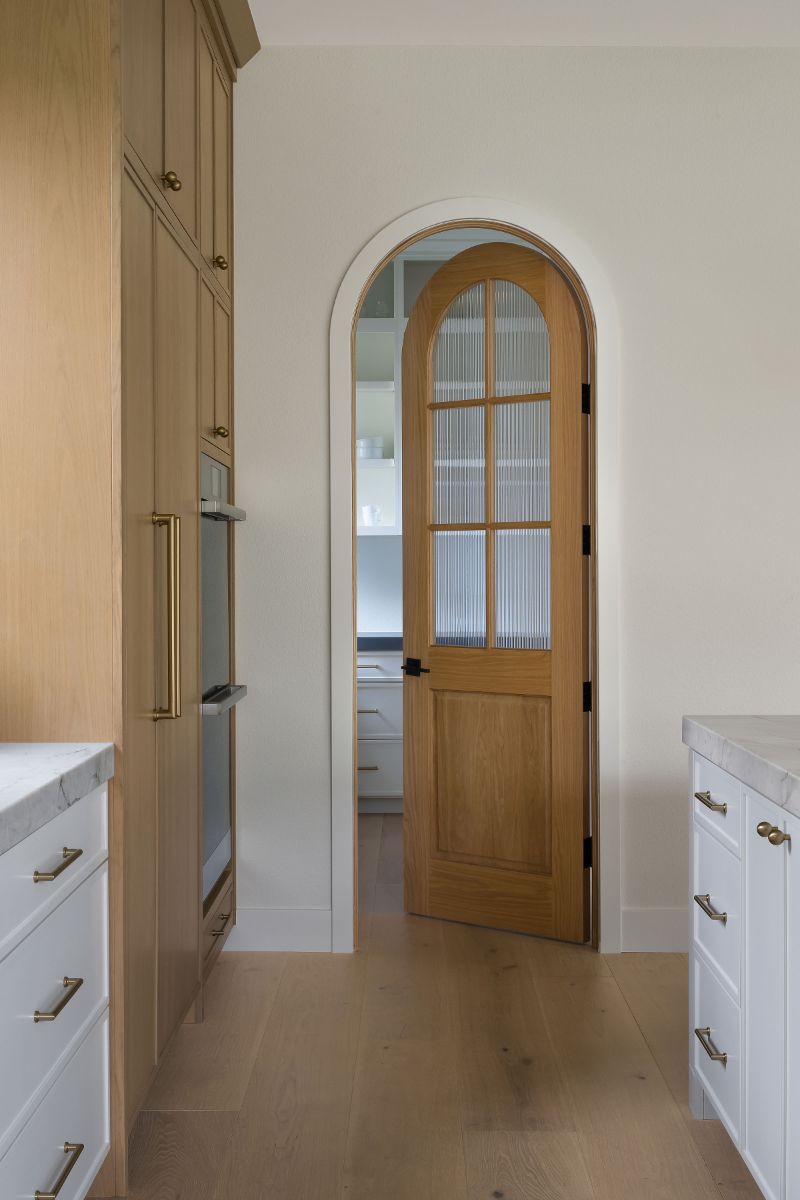detailed door arches and and soft transition in the entryway from kitchen